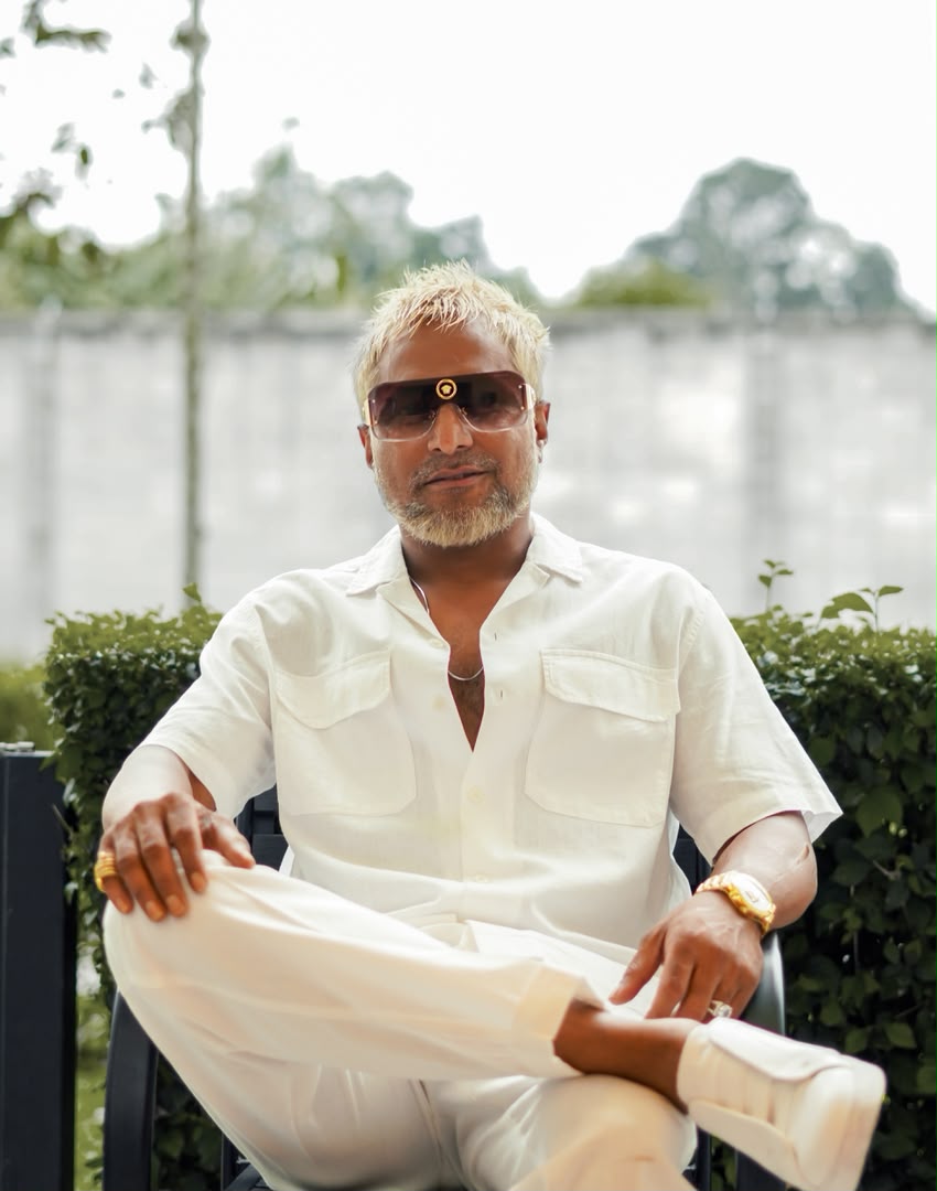 Portrait of DJ RICH in white linen and gold sunglasses
